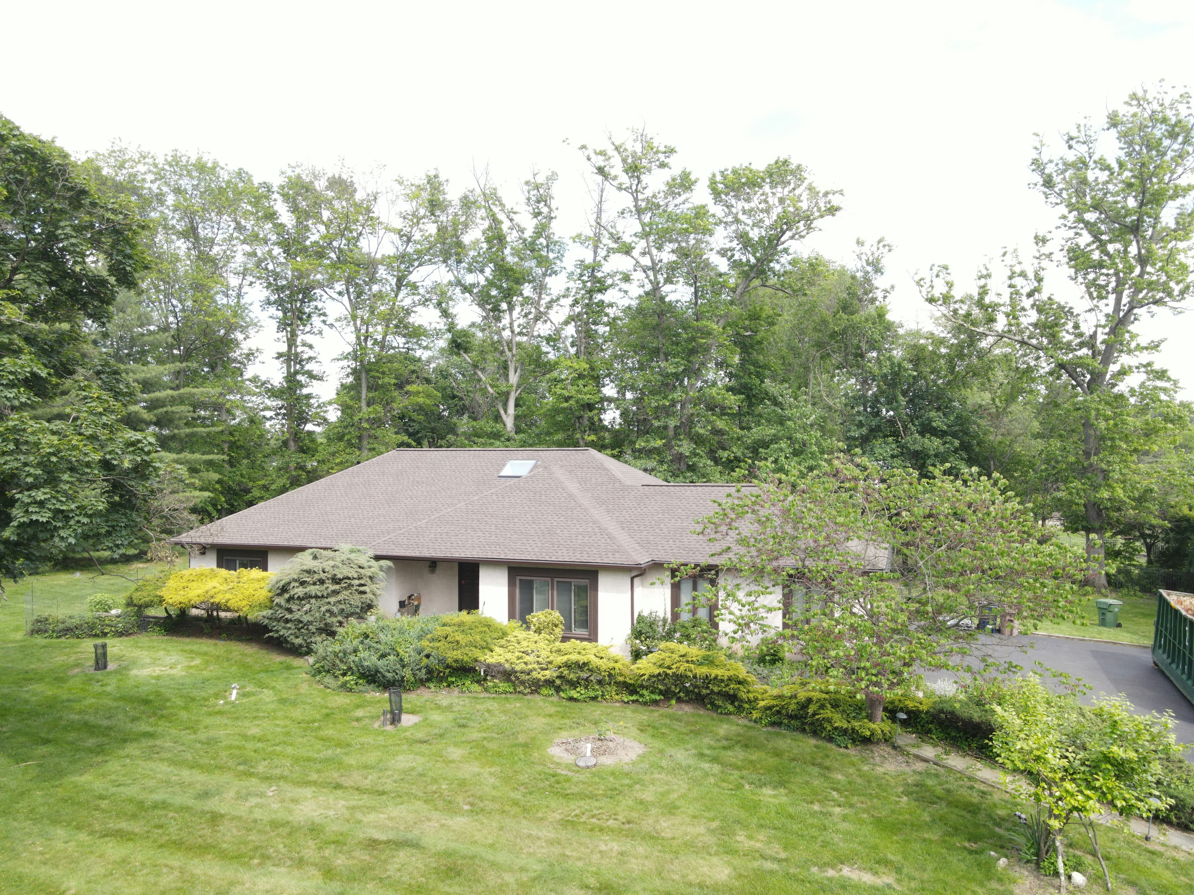 Residential home viewed from above showing the complete roof